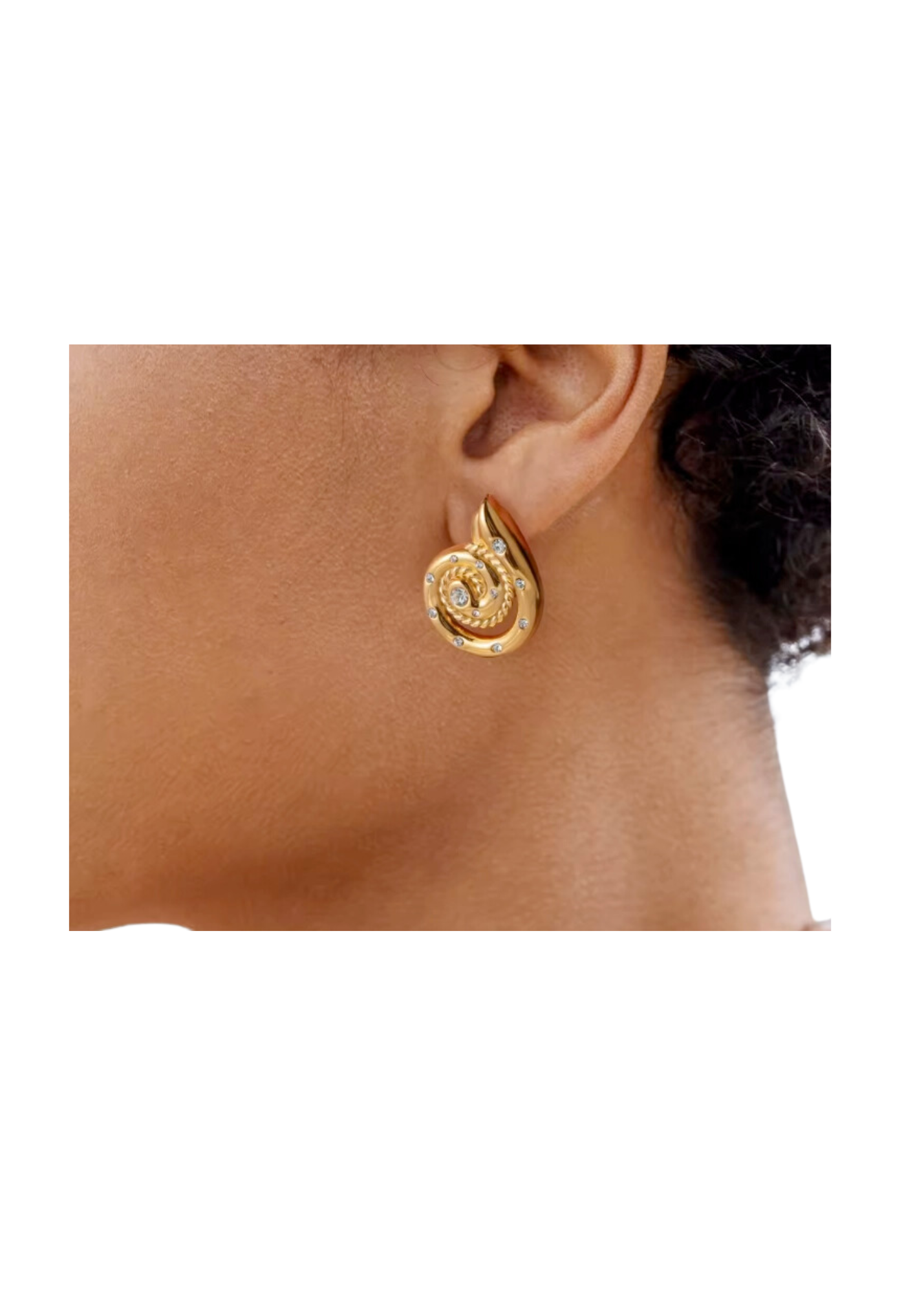 A woman wearing the 14K gold PV plated earrings with a vintage button design, hammered and puffy finish. Hypoallergenic stainless steel with hand-set crystals, featuring a snail, conch, and beach-inspired motif. Waterproof and long-lasting